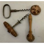 Two antique corkscrews, a pastry crimper and a small copper mould