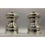 A pair of silver salt and pepper mills of circular baluster form hallmarked London 1993 and 1994 for