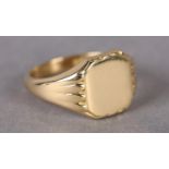 A SIGNET RING in 18ct gold, the rounded octagonal head with incised shoulders and surround,
