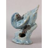 A CHINESE STONEWARE FIGURE OF A HAWK perched on a rock, blue-grey glaze, impressed signature to