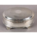 A GEORGE V SILVER JEWELLERY BOX, engine turned hinged top of oval outline, with four tapered and