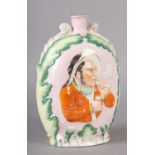 A MID-19TH CENTURY STAFFORDSHIRE POTTERY FLASK of oval outline moulded in relief to front and back