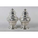 A PAIR OF GEORGE II SILVER CADDIES, Alexander Johnson, London 1757, of writhen baluster vase form