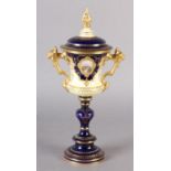 A COALPORT CHINA TWO-HANDLED VASE AND COVER with pierced knop, the body painted with a loch and