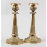 A PAIR OF ORMOLU CANDLESTICKS, octagonal having beaded sconce and stiff leaf collars to the stem and
