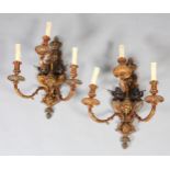 A PAIR OF GILT AND BRONZED METAL TRIPLE LIGHT WALL SCONES, cast as a crowned orb above a shield
