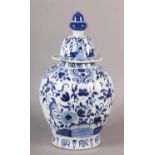 A 19TH CENTURY DELFT BLUE AND WHITE VASE AND DOMED COVER with acorn knop, painted in the chinoiserie