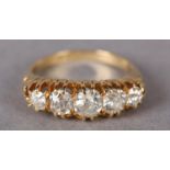 A VICTORIAN FIVE STONE DIAMOND RING in 18ct gold, the Old European cut stones claw set in line in