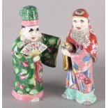TWO CHINESE CERAMIC FIGURES OF DEITIES, in elegant robes and head-dress, one holding a basket of