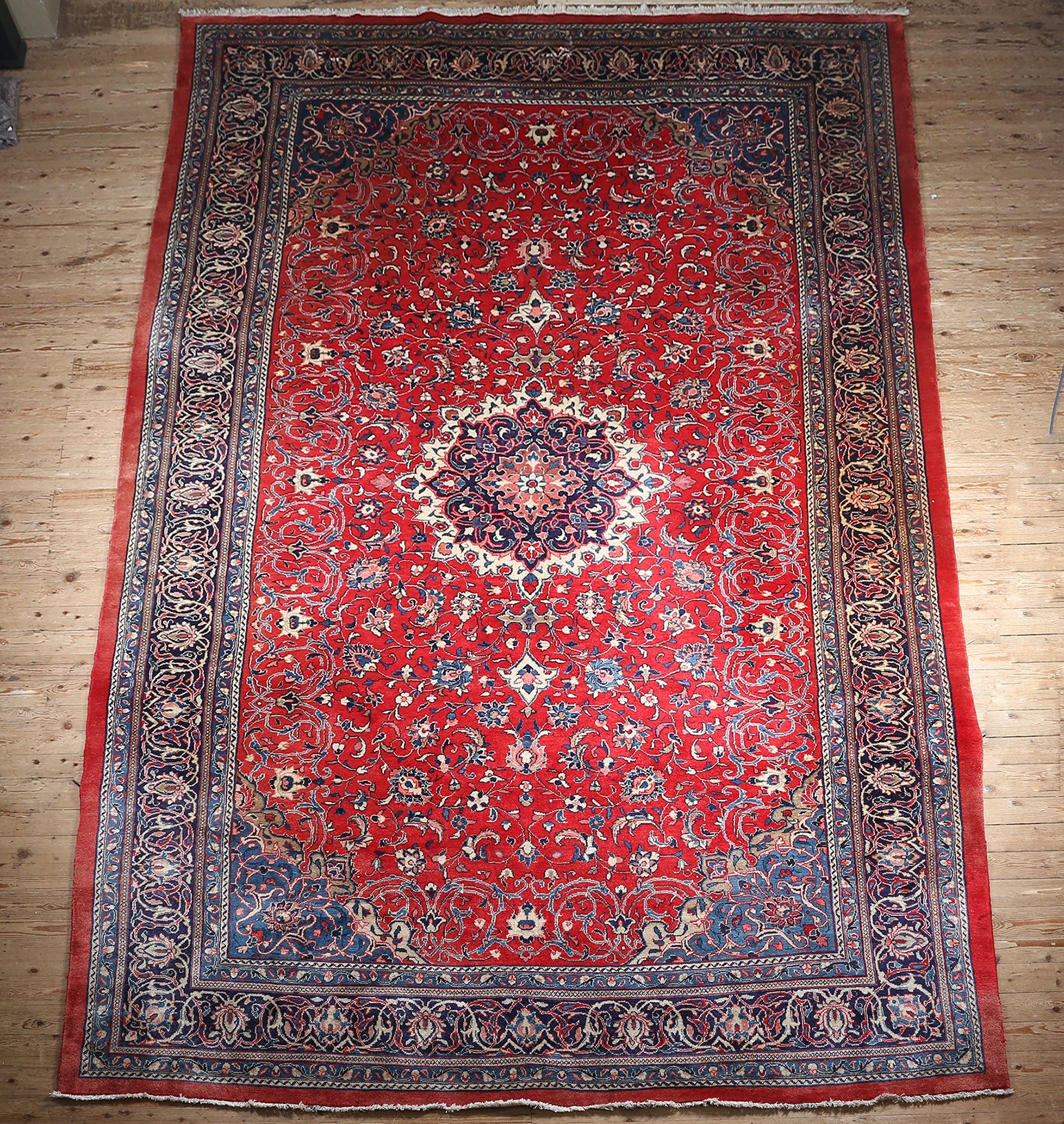 A MAHAL CARPET, the red field with central medallion within a surround of flowering leaf scrolls,