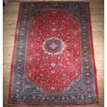 A MAHAL CARPET, the red field with central medallion within a surround of flowering leaf scrolls,