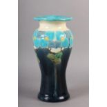 A BURMANTOFTS FAIENCE VASE, enamelled and incised with a band of flower heads on long stems, in