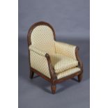 A CHILD'S FRENCH WALNUT ARMCHAIR, c.1920s, having a moulded frame to the arched panelled back,