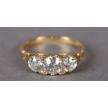 A VICTORIAN THREE STONE DIAMOND RING in 18ct gold, the Old European cut stones set in line