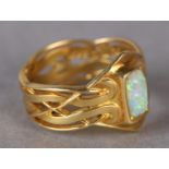 AN OPAL RING BY ARCHIBALD KNOX (1864-1933) FOR LIBERTY & CO in 18ct gold, C.1901, the rectangular