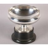 A GEORGE V SILVER ROSE BOWL of plain form with pierced gallery and conforming pedestal foot,