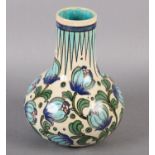 A BURMANTOFT FAIENCE ANGLO PERSIAN VASE BY LEONARD KING, in shades of blue, turquoise and green on a