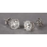 A PAIR OF DIAMOND STUD EARRINGS, the brilliant cut stones claw set in white metal (tests as 18ct