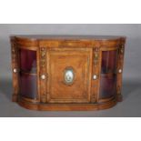 A MID 19TH CENTURY FIGURED WALNUT AND GILT METAL MOUNTED CREDENZA of semi bow front outline,