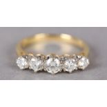 A FIVE STONE DIAMOND RING in 18ct yellow and white gold, the graduated brilliant cut stones claw set