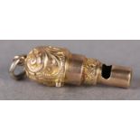 AN EDWARD VII WHISTLE in 9ct rose gold, fashioned as a cannon with foliate scroll engraving and