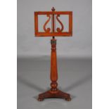 A VICTORIAN MAHOGANY MUSIC STAND with lyre pierced rest on adjustable turned pedestal, tripartite