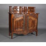 A 20TH CENTURY FRENCH PROVINCIAL CHESTNUT CABINET having a raised super structure with moulded