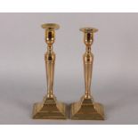 A PAIR OF LATE 18TH CENTURY NEOCLASSICAL BELL-METAL CANDLESTICKS, having cylindrical nozzles with