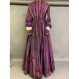 A fine and unusual striped purple silk dress c 1850’s, with tiered pagoda sleeves, finished with