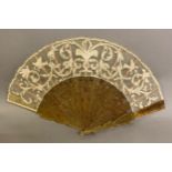 A mid-19th century horn fan with very decorative monture, shaped into shields just below the