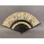 A large late 19th century wood fan, the guards shaped and painted, the leaf mounted in cabriolet