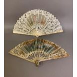 An early 20th century Brussels tape lace fan with central painted gauze depiction of a courting