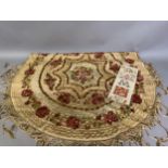 A circular, silk embroidered table cover, with floral design, macramé fringing, worked in concentric