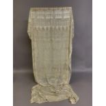 1920’s, a wide cream azute or assuit shawl, the pressed silver decoration in multiple bands of