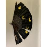 A late 19th century black feather fan, the monture of tortoiseshell, the feathers painted in gold