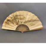 A large late 19th century wood fan by Buissot Eventails Paris, the double paper leaf printed to