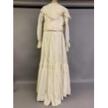 A cream Edwardian two-piece costume, the high-necked bodice boned, with waist tie, an inside panel