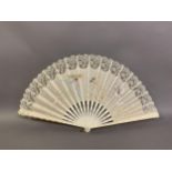 c1890s, a large incised bone fan, the cream silk leaf painted with winged cherubs carrying fruits