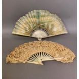 A moth or butterfly fan, the paper leaf shaped, with embossed gold decoration and minute gold