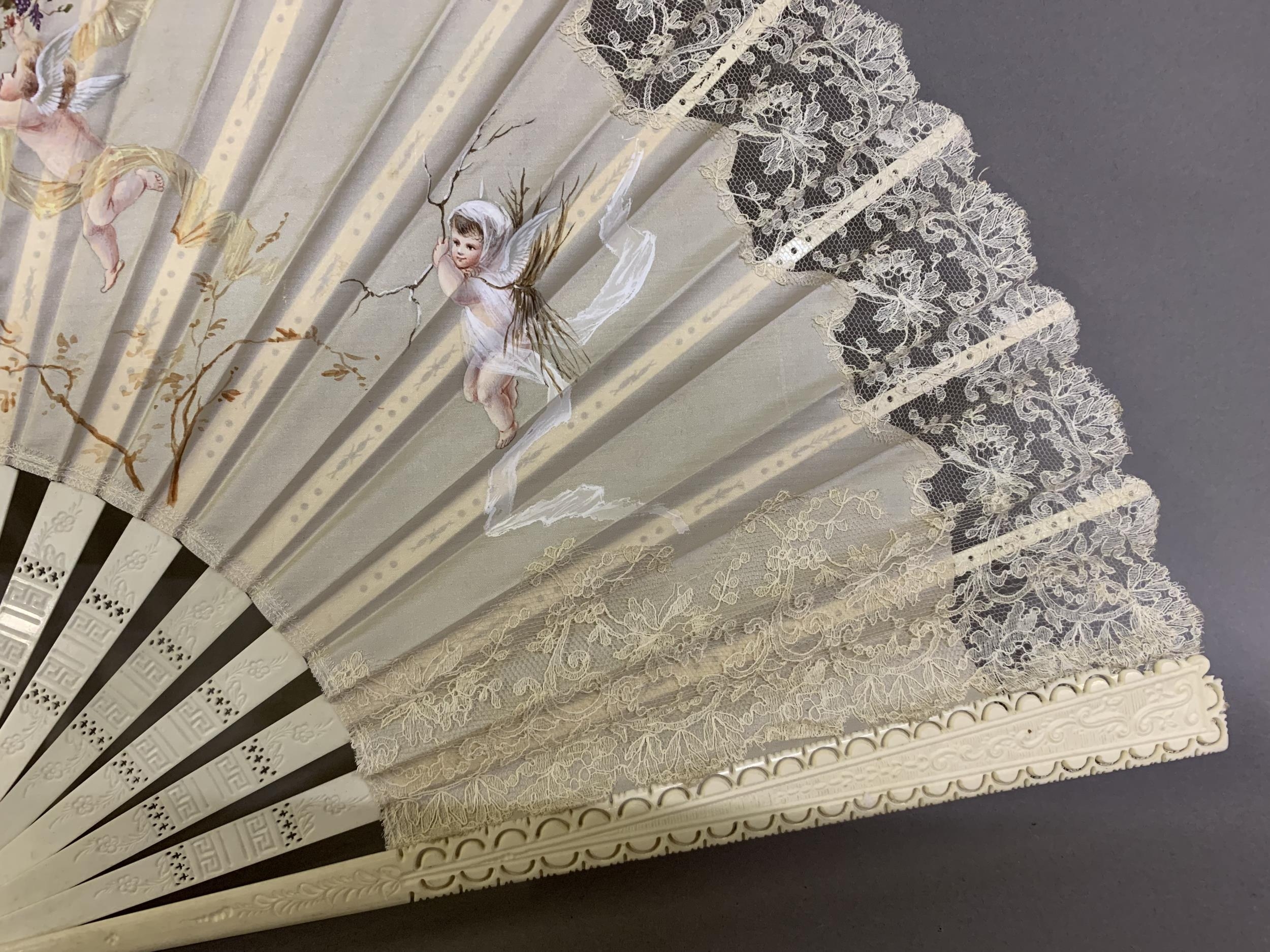 c1890s, a large incised bone fan, the cream silk leaf painted with winged cherubs carrying fruits - Image 3 of 4