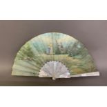 A white mother of pearl and painted silk fan, early 20th century, a gentle scene set by water, a