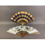 Japanese fans: A dramatic gold and navy blue horizontal striped paper fan with double leaf, design