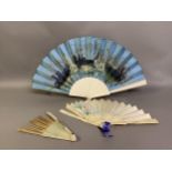 A c 1890’s topographical fan, the plain bone monture mounted with a silk leaf in turquoise blue,