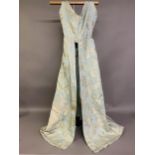 A silk gown bearing the woven waist label of Eliza Pultz, 27 Dover Street, London, the aqua silk