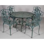 A green metal garden table and four open armchairs, the table 101cm diameter (one chair arm requires