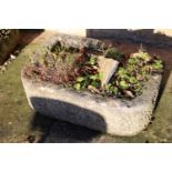 A stone trough, flat back and curved front with low back corner, 57cm x 41cm x 22cm high