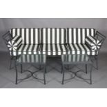 A Kettal of Barcelona metal garden sofa with black and white striped cushions together with a pair