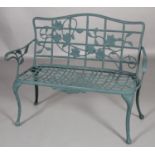 A green metal two seater garden bench , 120cm wide