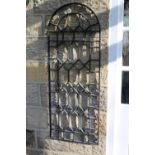 A pair of wrought iron wall trellises of arched profile 47cm by 123cm