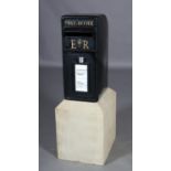 A black enamelled house post box with ER cypher and collecting times raised on stone plinth box,